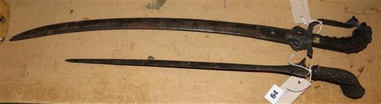 Indian sword with mythical beast hilt & a Kris with pierced hardwood hilt (faults)
